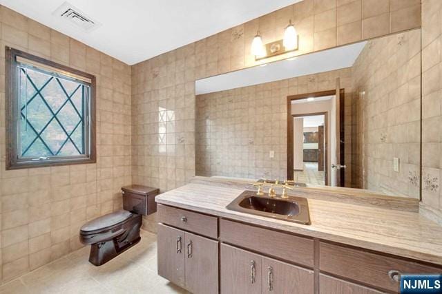 23 Bohnert Pl, Waldwick, NJ 07463 - bathroom with tile walls, toilet, vanity, and tile patterned flooring