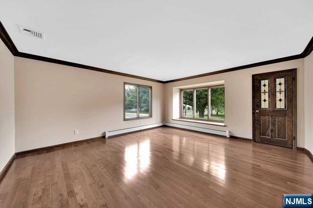 23 Bohnert Pl, Waldwick, NJ 07463 - unfurnished living room featuring ornamental molding, wood finished floors, and baseboards