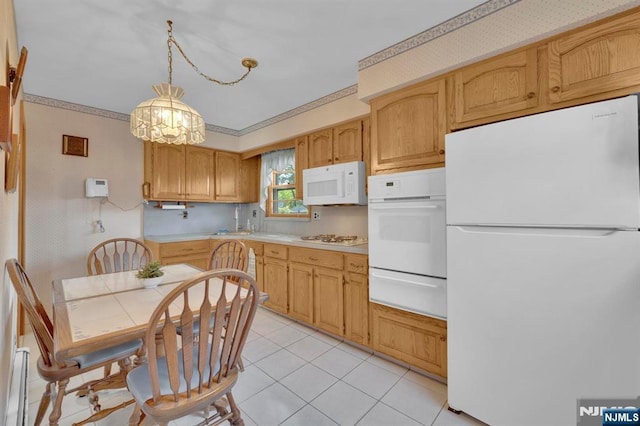 13 Wonham St, Clifton, NJ 07013 - kitchen featuring white appliances, a warming drawer, light countertops, light tile patterned floors, and a chandelier