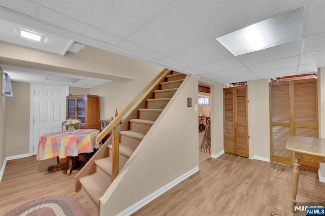 13 Wonham St, Clifton, NJ 07013 - finished basement with wood finished floors, a paneled ceiling, stairway, and baseboards