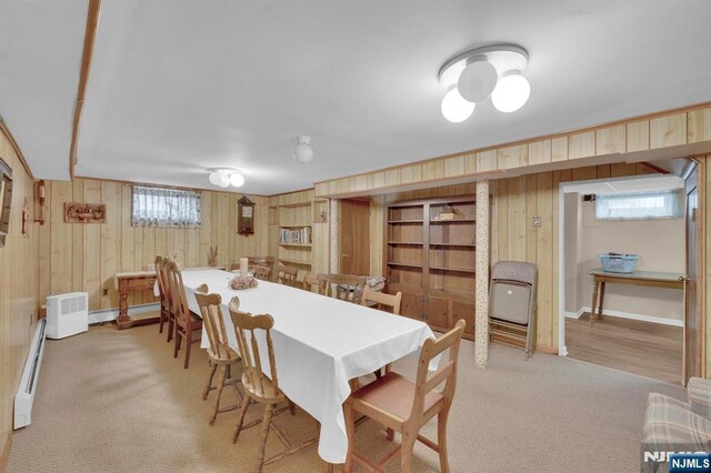 13 Wonham St, Clifton, NJ 07013 - dining space with wooden walls, light carpet, baseboard heating, and healthy amount of natural light