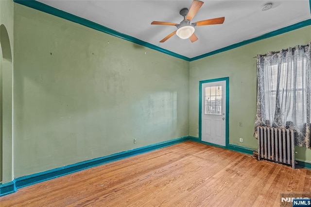 300 2nd St Unit 2, Jersey City, NJ 07302 - empty room with radiator, a ceiling fan, wood finished floors, baseboards, and a smoke detector
