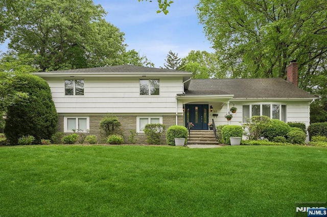 13 Stonewall Dr, Livingston, NJ 07039 - tri-level home featuring a chimney and a front yard