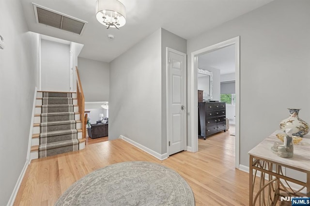 13 Stonewall Dr, Livingston, NJ 07039 - foyer with light wood finished floors, baseboards, and stairway