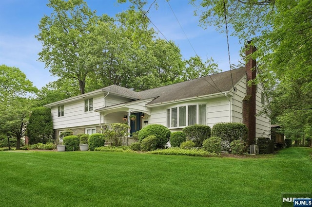 13 Stonewall Dr, Livingston, NJ 07039 - tri-level home featuring a front yard and a chimney