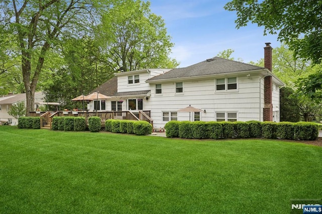 13 Stonewall Dr, Livingston, NJ 07039 - rear view of house with a chimney, a lawn, and a wooden deck