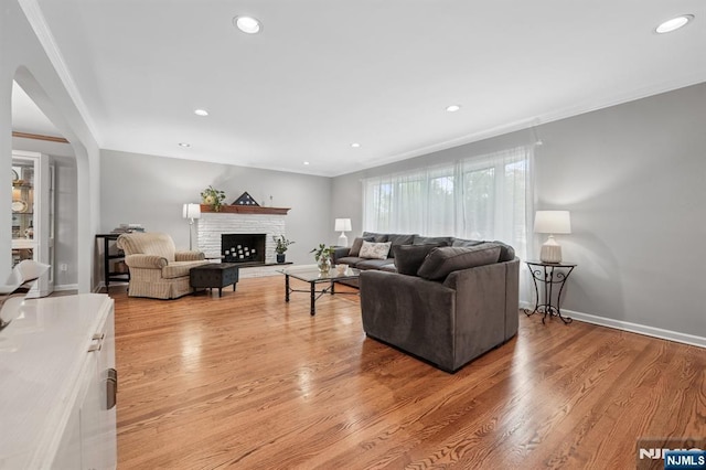 13 Stonewall Dr, Livingston, NJ 07039 - living area featuring ornamental molding, a fireplace with raised hearth, light wood-style flooring, recessed lighting, and baseboards