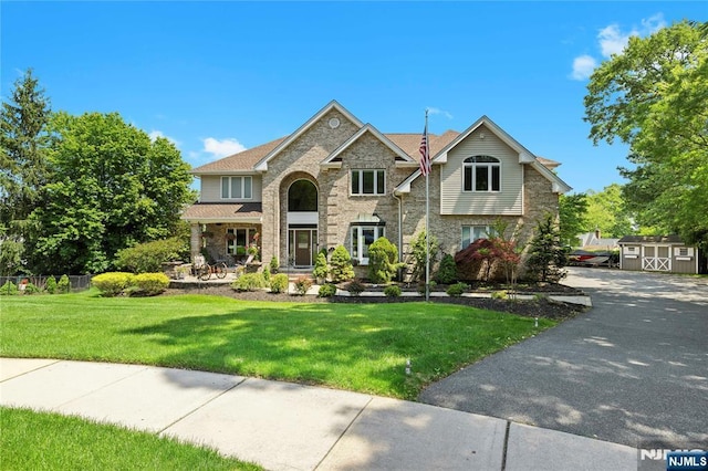 12 Woodland Ct, Wayne, NJ 07470 - traditional-style home with a front yard, brick siding, asphalt driveway, and a porch