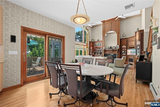 12 Woodland Ct, Wayne, NJ 07470 - dining room with a baseboard heating unit, healthy amount of natural light, light wood-style flooring, wallpapered walls, and baseboards