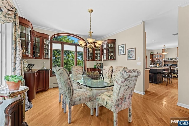 12 Woodland Ct, Wayne, NJ 07470 - dining space featuring a chandelier, crown molding, light wood-style flooring, baseboards, and a baseboard radiator