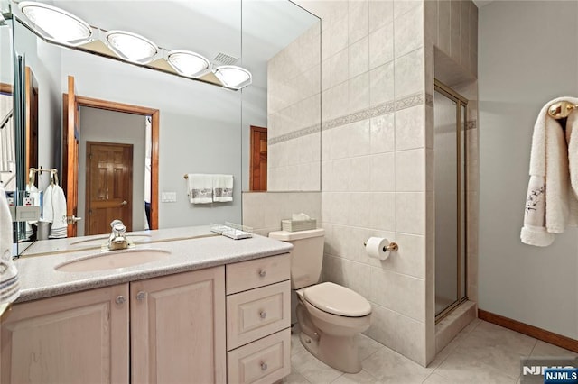 12 Woodland Ct, Wayne, NJ 07470 - bathroom with tile walls, tile patterned flooring, a stall shower, vanity, and toilet