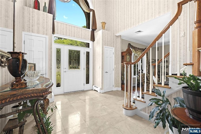12 Woodland Ct, Wayne, NJ 07470 - entrance foyer featuring baseboard heating, crown molding, stairway, a high ceiling, and baseboards
