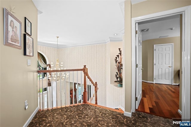 12 Woodland Ct, Wayne, NJ 07470 - hallway with baseboards, a chandelier, wood finished floors, ornamental molding, and wallpapered walls