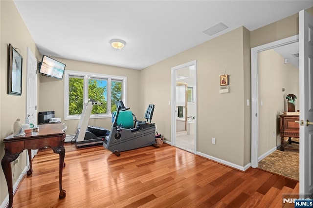 12 Woodland Ct, Wayne, NJ 07470 - workout area with wood finished floors, baseboards, and a baseboard radiator