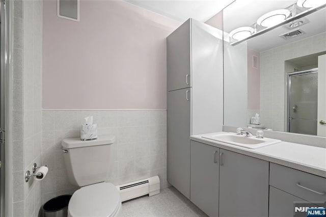 12 Woodland Ct, Wayne, NJ 07470 - bathroom with a baseboard heating unit, vanity, tile walls, toilet, and a shower stall