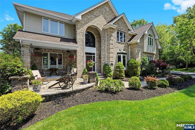12 Woodland Ct, Wayne, NJ 07470 - traditional-style home featuring brick siding, a shingled roof, and a front yard