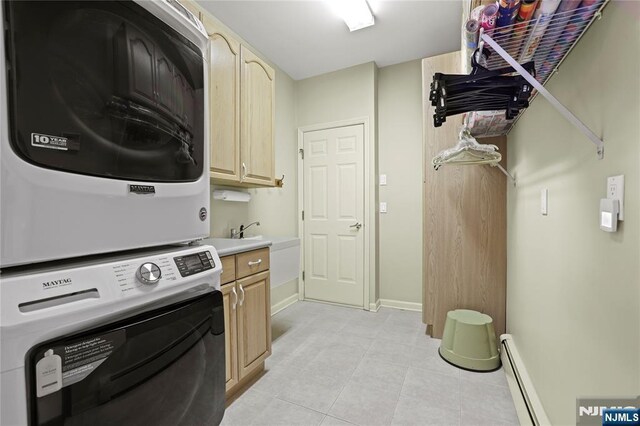 12 Woodland Ct, Wayne, NJ 07470 - washroom featuring stacked washer and clothes dryer, cabinet space, a baseboard radiator, light tile patterned floors, and baseboards