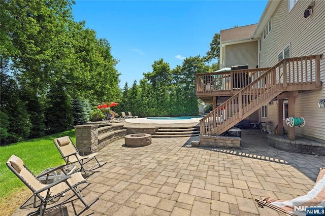 12 Woodland Ct, Wayne, NJ 07470 - view of patio featuring an outdoor fire pit, stairs, a wooden deck, and an outdoor pool