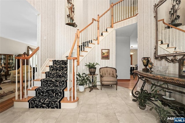 12 Woodland Ct, Wayne, NJ 07470 - staircase featuring wallpapered walls, crown molding, and a high ceiling