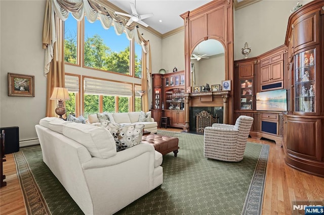 12 Woodland Ct, Wayne, NJ 07470 - living room with a ceiling fan, a towering ceiling, crown molding, light wood-type flooring, and a premium fireplace
