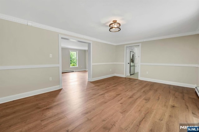 1582 Grnwd Lk, West Milford, NJ 07421 - spare room with wood finished floors, ornamental molding, baseboards, a baseboard heating unit, and washer / dryer
