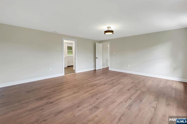 1582 Grnwd Lk, West Milford, NJ 07421 - spare room featuring baseboards, wood finished floors, and a baseboard radiator