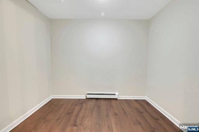 1582 Grnwd Lk, West Milford, NJ 07421 - empty room featuring a baseboard heating unit, wood finished floors, and baseboards