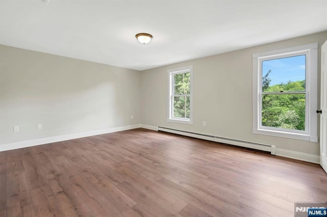 1582 Grnwd Lk, West Milford, NJ 07421 - spare room featuring a baseboard radiator, hardwood / wood-style floors, and baseboards