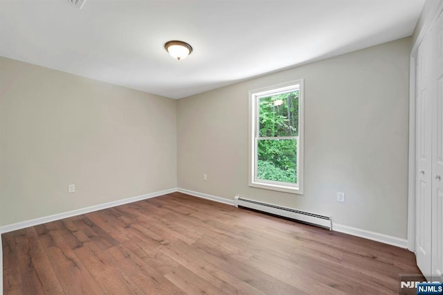 1582 Grnwd Lk, West Milford, NJ 07421 - empty room featuring a baseboard radiator, wood finished floors, and baseboards