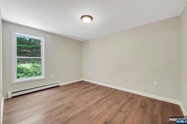1582 Grnwd Lk, West Milford, NJ 07421 - unfurnished room with baseboard heating, wood finished floors, and baseboards