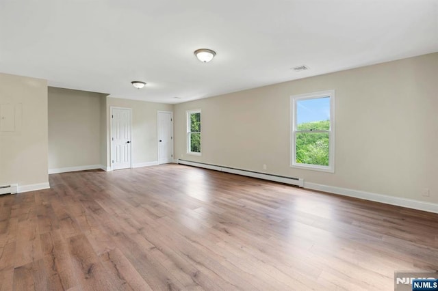 1582 Grnwd Lk, West Milford, NJ 07421 - unfurnished room with a baseboard heating unit, wood finished floors, and baseboards