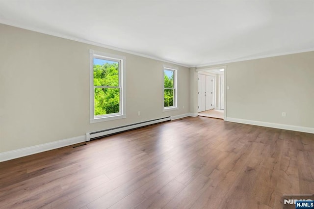 1582 Grnwd Lk, West Milford, NJ 07421 - empty room with a baseboard radiator, crown molding, wood finished floors, and baseboards
