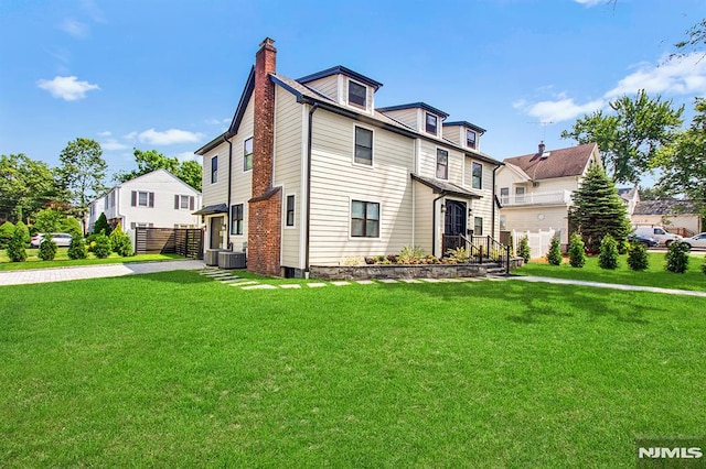 309 Clinton Ave, Bergenfield, NJ 07621 - view of front facade with a chimney