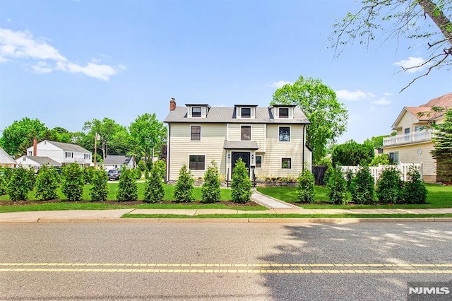 309 Clinton Ave, Bergenfield, NJ 07621 - view of front facade with a chimney