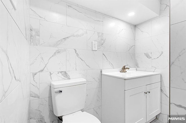 309 Clinton Ave, Bergenfield, NJ 07621 - half bathroom featuring tile walls and vanity