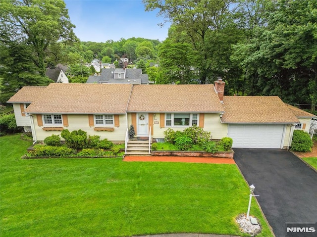 7 Meadow Ct, Midland Park, NJ 07432 - view of front of home featuring asphalt driveway, a chimney, a front lawn, and an attached garage