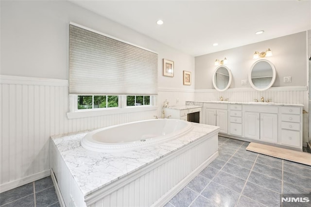 7 Meadow Ct, Midland Park, NJ 07432 - bathroom featuring double vanity, wainscoting, a garden tub, tile patterned flooring, and recessed lighting