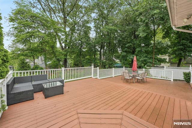 7 Meadow Ct, Midland Park, NJ 07432 - deck featuring outdoor lounge area, outdoor dining space, and view of scattered trees