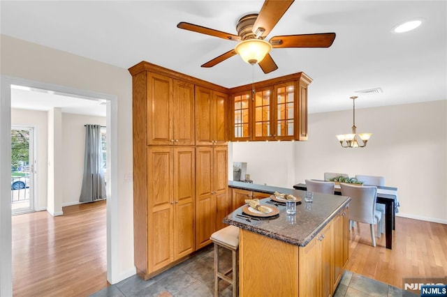 8 Delmar Ave, Cresskill, NJ 07626 - kitchen with a ceiling fan, baseboards, glass insert cabinets, and brown cabinets