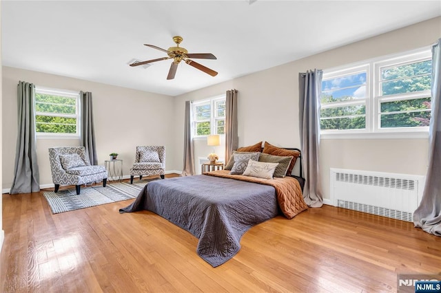 8 Delmar Ave, Cresskill, NJ 07626 - bedroom with radiator, multiple windows, wood finished floors, and baseboards