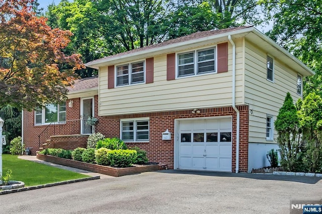8 Delmar Ave, Cresskill, NJ 07626 - split level home featuring an attached garage, brick siding, driveway, and a shingled roof