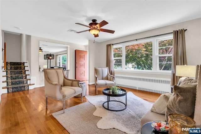 8 Delmar Ave, Cresskill, NJ 07626 - living area featuring radiator, ceiling fan, stairway, and healthy amount of natural light