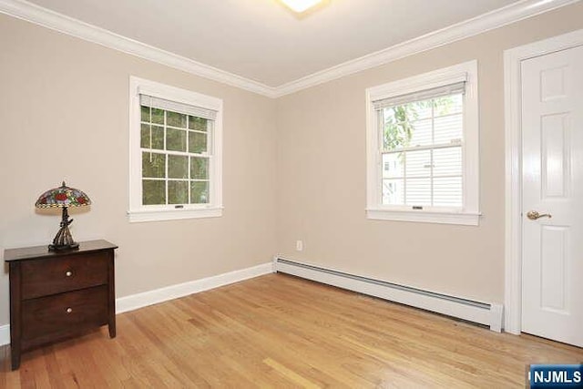 55 Beech St, Westwood, NJ 07675 - spare room featuring a baseboard radiator, healthy amount of natural light, ornamental molding, and light wood-style floors