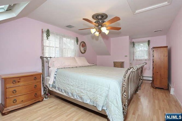 55 Beech St, Westwood, NJ 07675 - bedroom with light wood finished floors, attic access, a baseboard radiator, and ceiling fan