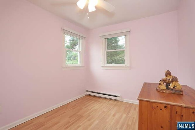 55 Beech St, Westwood, NJ 07675 - empty room with a baseboard heating unit, light wood finished floors, and a ceiling fan
