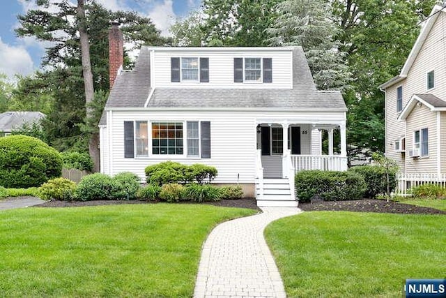 55 Beech St, Westwood, NJ 07675 - view of front facade featuring a porch, a front lawn, a chimney, and a shingled roof
