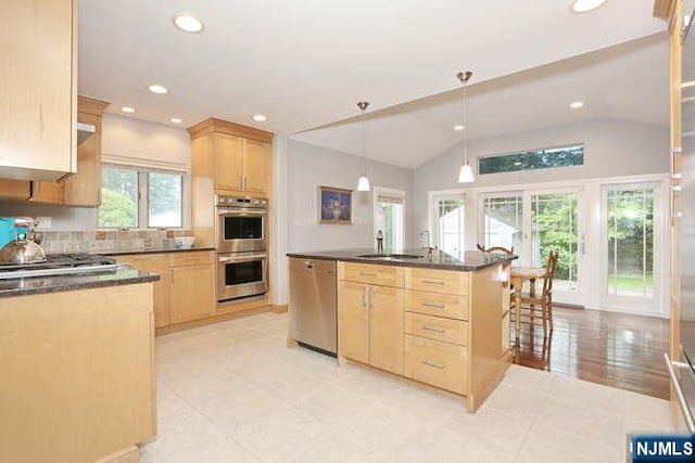 55 Beech St, Westwood, NJ 07675 - kitchen with appliances with stainless steel finishes, light brown cabinetry, dark countertops, recessed lighting, and vaulted ceiling