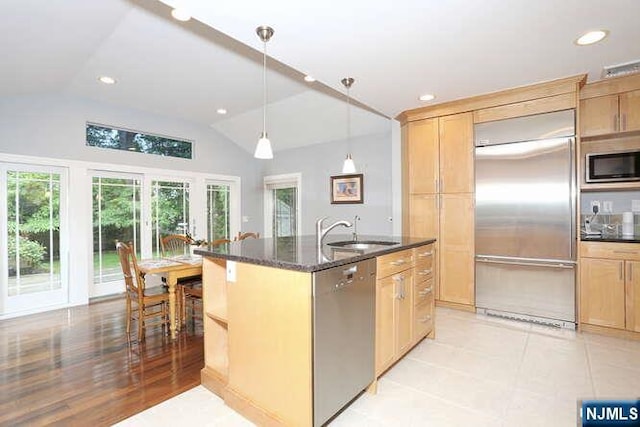 55 Beech St, Westwood, NJ 07675 - kitchen featuring built in appliances, lofted ceiling, an island with sink, dark stone counters, and recessed lighting