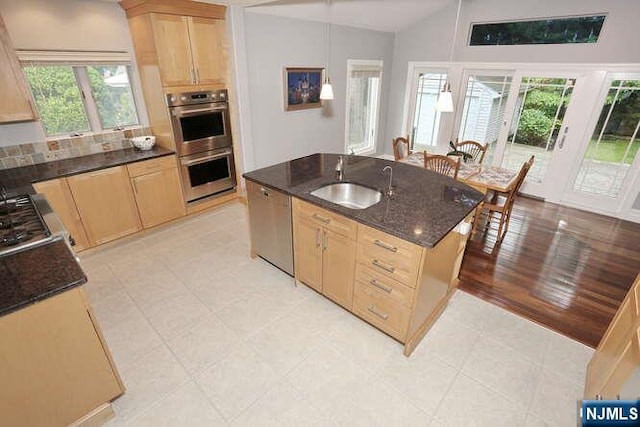 55 Beech St, Westwood, NJ 07675 - kitchen featuring light brown cabinetry, stainless steel appliances, an island with sink, dark stone countertops, and lofted ceiling