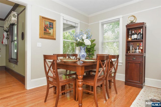  - dining area featuring light wood-type flooring and ornamental molding